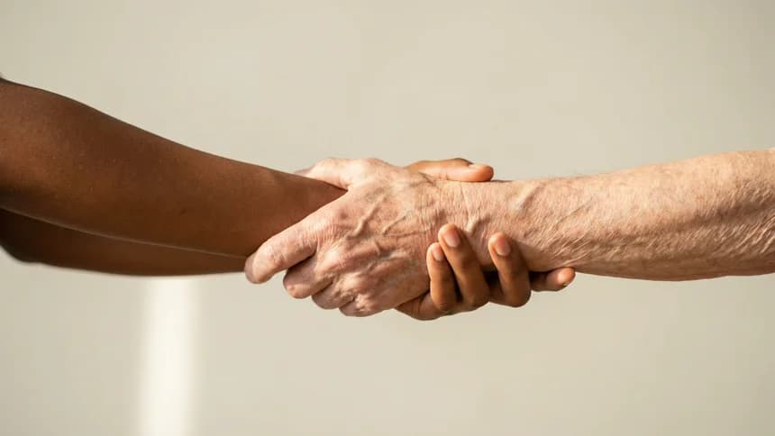 Two hands clasped in a supportive wrist hold